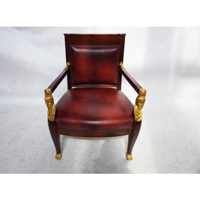 Mid 20th Century Red Leather Empire Style Armchair With Gilded Figures This exquisite Empire Style chair with large gold...