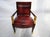Mid 20th Century Red Leather Empire Style Armchair With Gilded Figures This exquisite Empire Style chair with large gold...
