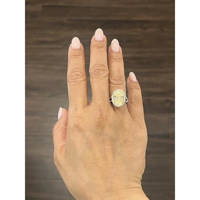 This showstopper of a piece is breathtaking. The ring features a 4.57 ct natural yellow center stone with 0.68 ct diamonds...