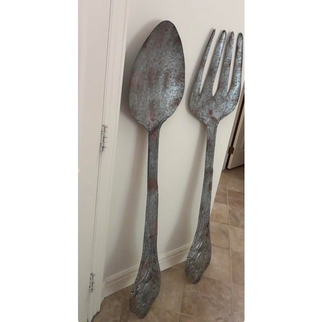 Galvanized metal spoon and fork wall decor has a rustic appearance. Each piece has decorative handles. Cast Aluminum with...
