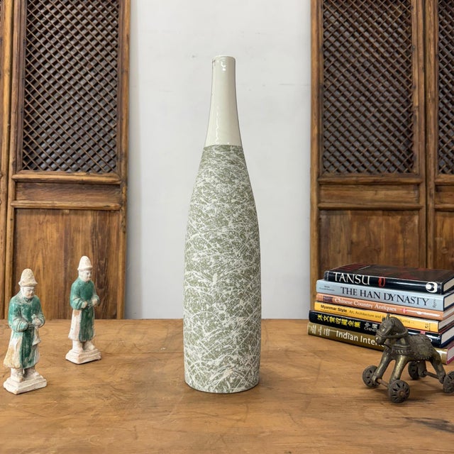 "About This Piece About This Piece This vase is a celebration of spontaneity and movement, its surface alive with an...