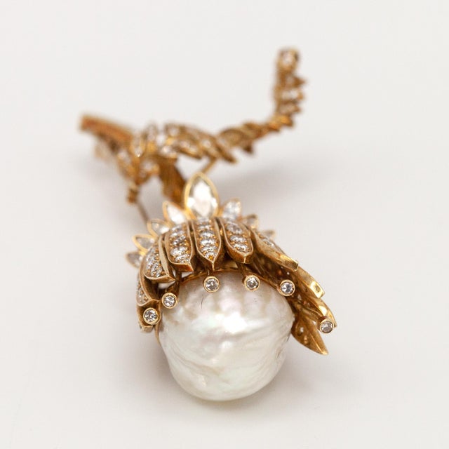 1960s 18K yellow gold diamond baroque pearl flower brooch set with 162 round diamonds 9 marquise diamonds and 7 baguette...