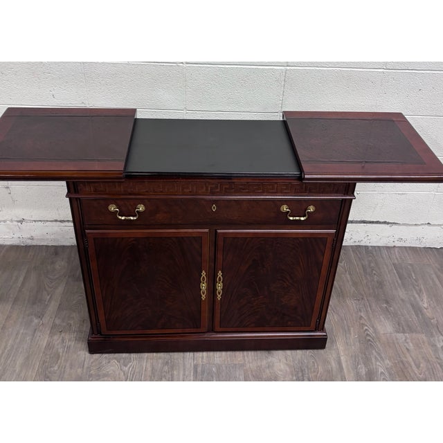 This is a gorgeous vintage Drexel mahogany expandable server cabinet featuring richly figured flame mahogany door panels,...