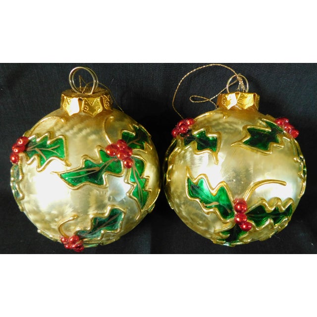 Beautiful set of two medium vintage gold foil shmmer glass ornaments with hand painted red & green mistletoe. They are...