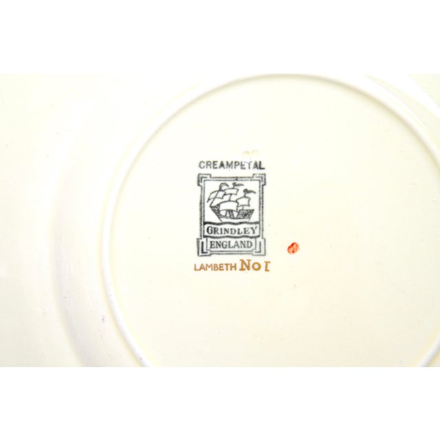 A set of twelve creamware dinner plates from circa 1930s-'50s, embellished with hand-painted gilding and turquoise enamel...