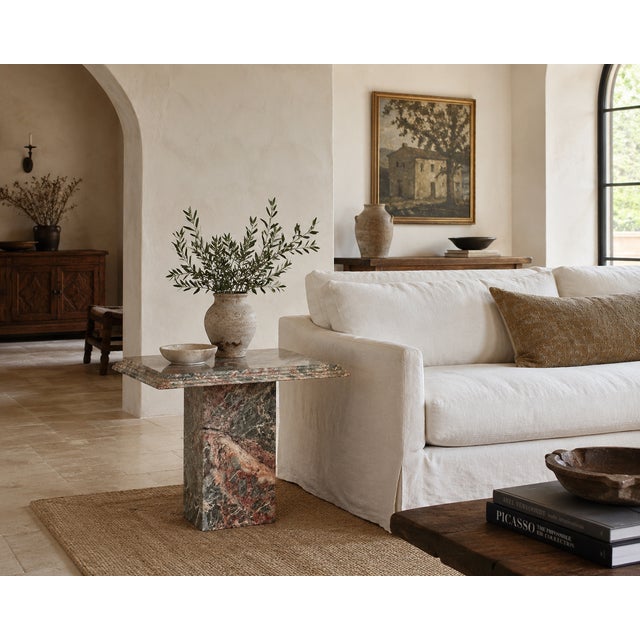 Cut from a single slab of Fior di Pesco marble, this vintage side table wears the stone's signature grey ground and soft...