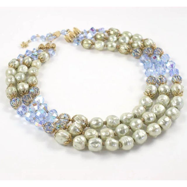 This is part of Chairish’s Costume Jewelry assortment. Three strand graduated necklace of faux baroque pearls and pale...