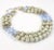 This is part of Chairish’s Costume Jewelry assortment. Three strand graduated necklace of faux baroque pearls and pale...