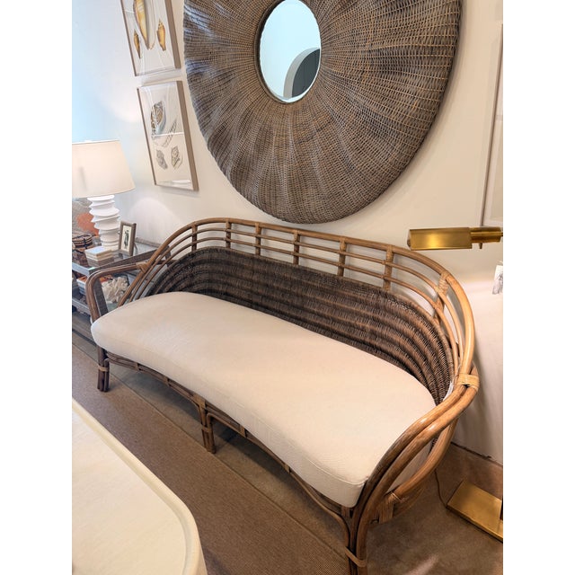 This charming rattan settee sofa brings effortless coastal style and natural warmth to any space. Crafted from natural...