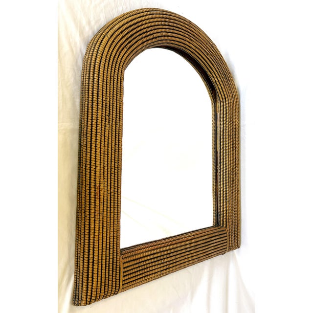 Great coastal style wall mirror from the 1970's. The frame is made of a lightweight composite wood material with a wicker...