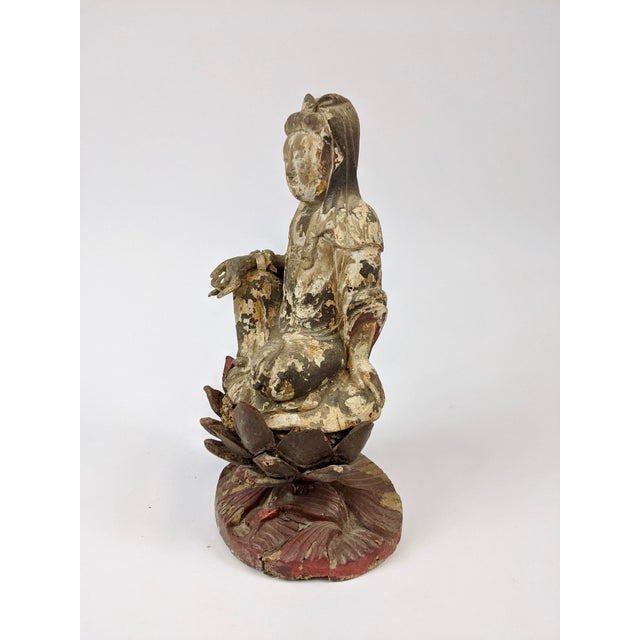 Hand carved wooden sitting Goddess of Mercy on a lotus stand. The Goddess of Mercy or Guan Yin is the goddess of...