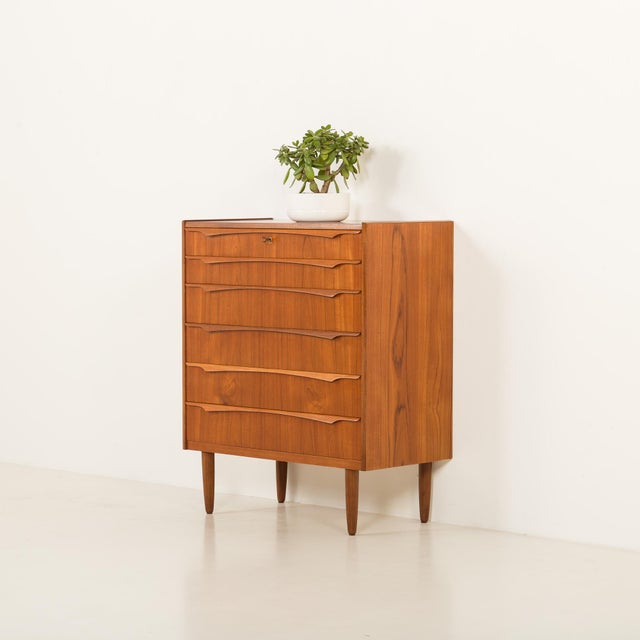 A classic mid-century teak chest of drawers was manufactured by small danish factory genega mobler in the 1960s. overall...