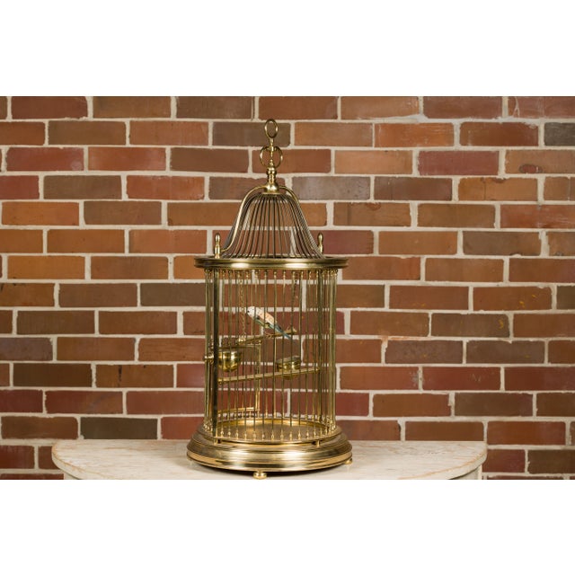 This French brass circular birdcage from the Midcentury period is a delightful combination of form and whimsy, perfect for...