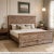 Dimensions: 82" W x 81" D x 60" H This king bed has been crafted using reclaimed wood with distressed white patina. The...