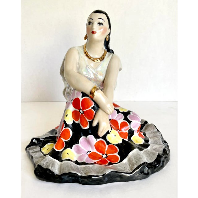 Here is a beautiful hand-painted figurine of a woman in a full floral skirt made in USSR in the 1960's. The woman features...