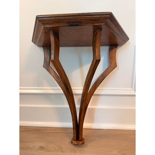 Sculptural wooden wall bracket by Global Views, featuring an elegant architectural form with four gracefully curved...