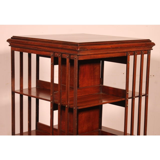 Exquisite 19th-century mahogany revolving bookcase with an iron base and a top featuring inlaid decoration and a...