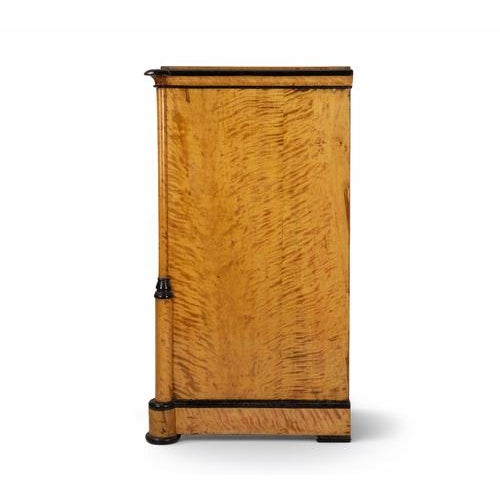 A refined Biedermeier chest of drawers from the mid-19th century, exemplifying the elegant simplicity and craftsmanship of...