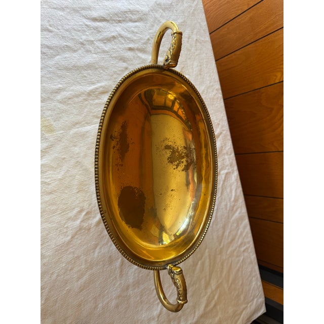 Brass compote with beaded edge, koi fish handles and ribbed pedestal base. Measures about 9 x 12 inches. With the handles...
