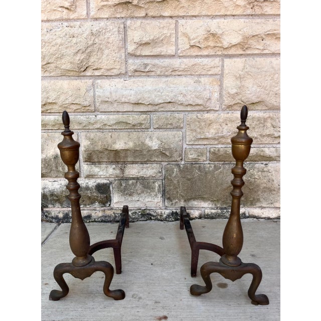 Pair of antique brass andirons with turned columns, spire top and claw feet. Brass has a wonderful patina.