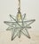 Modern style pendant light with a Moravian star shape with clear textured glass panels with welded seams. The chain is...