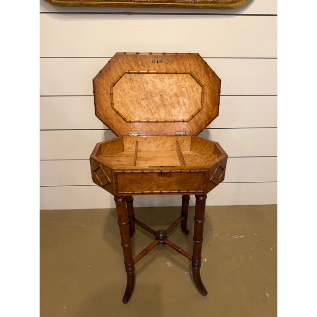 This is a unique English faux-bamboo sewing table with storage. The lovely patina to the octagonal top and faux bamboo...