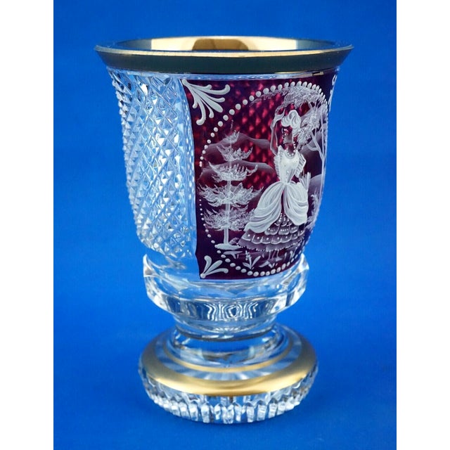 A delightful cup-shaped vase, made of very thick, entirely hand-cut crystal, clear in some areas and red in others,...
