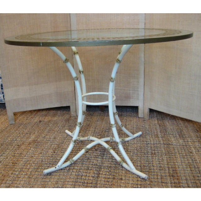 Bring classic Palm Beach and Hollywood Regency style into your home with this elegant vintage faux bamboo table featuring...