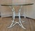 Bring classic Palm Beach and Hollywood Regency style into your home with this elegant vintage faux bamboo table featuring...