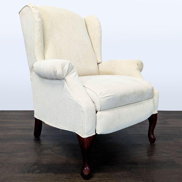 Comfortable and stylish wingback recliner by Lane Furniture. Features soft beige upholstery, classic rolled arms, and...