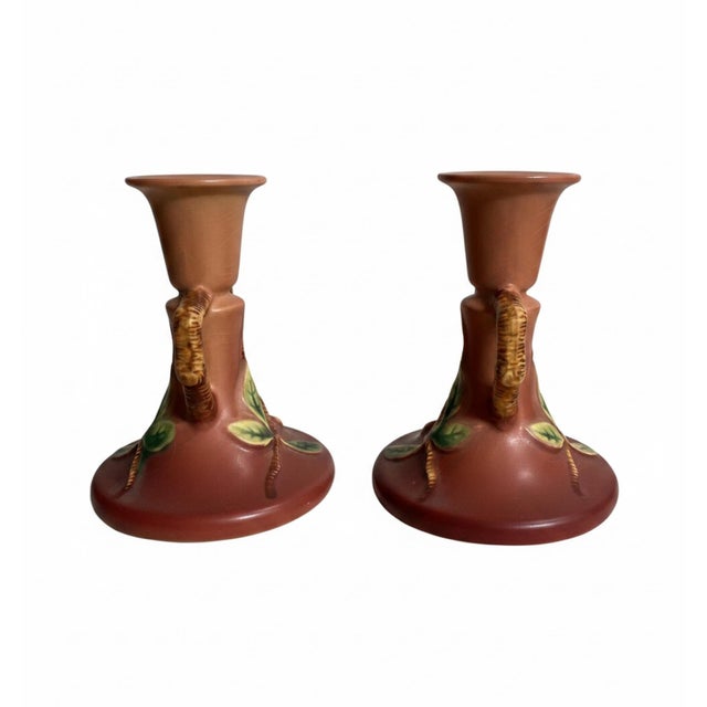 A lovely matched pair of vintage Roseville Pottery candlesticks in the classic Apple Blossom pattern, shape 352-4½. Each...