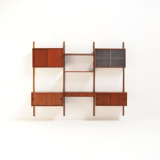 Danish modular wall system, designed by Poul Cadovius in the 1950s. It’s made of teak wood and designed to be mounted...