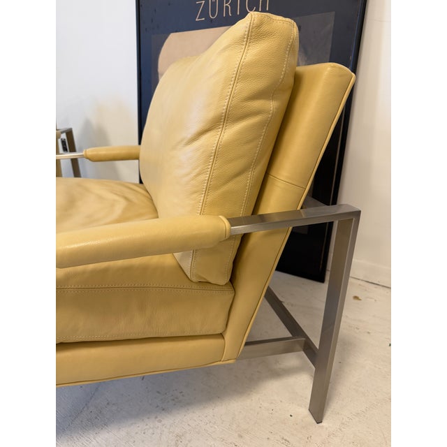 Description: These beautiful stainless steel and full-grain leather lounge armchairs are by Milo Baughman for Thayer...