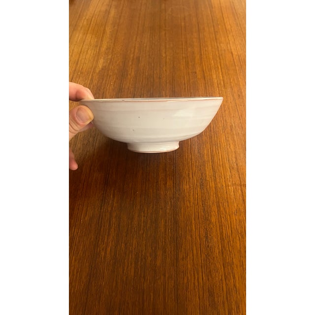 Blue glazed earthenware bowl with floral decoration, signed by the brothers Jean and Robert Cloutier, known as the...