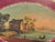 Oval French tole tray from the 19th century featuring a richly painted harbor scene at center, bordered by a deep red...