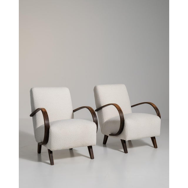 A cream wood armchair by Jindřich Halabala, dating to the 20th century and made in Czechia. The wood frame is finished in...