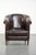 This dark sheepskin club armchair in the English style features a unique design and a desirable patina. It comes with a...