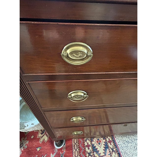 A classic Federal style mahogany American antique chest of drawers having 4 drawer with handsome oval brasses, with reeded...