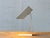An architecturally minimalist table lamp from the 1980s with a clear, geometric design. Made of folded sheet metal, the...