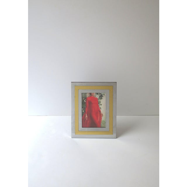 A chrome and brass picture frame, '70s Modern design period, circa late-20th century, 1970s. Frame can sit vertically or...