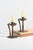 A pair of antique Goberg candle holders in hand-worked steel or iron, featuring a circular riveted base with geometric...