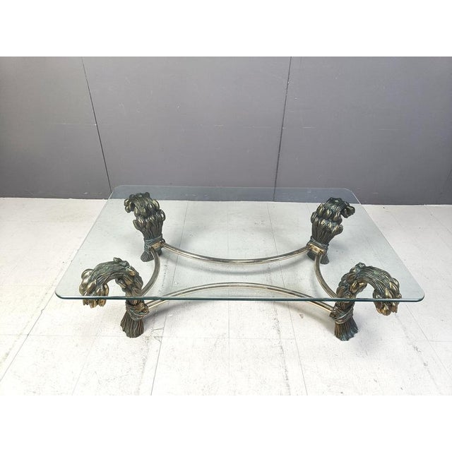 Elegant brass tulip flower coffee table very much in the style of Willy Daro. This coffee table is beautifully detailed. A...