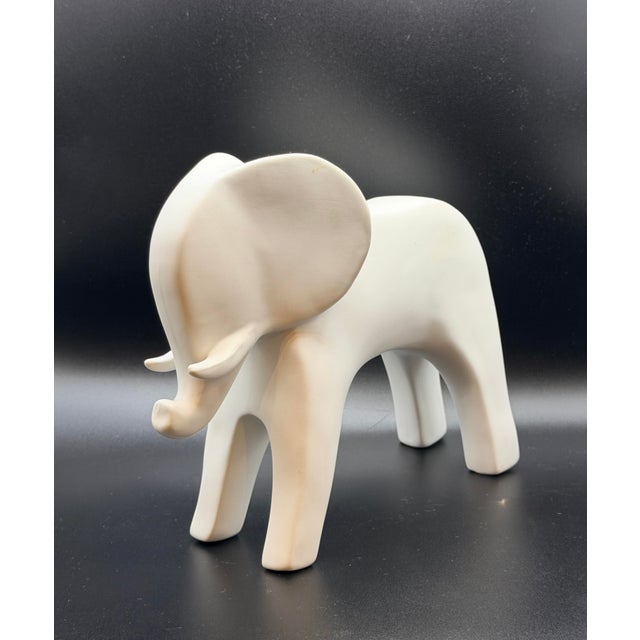 A beautifully sculpted matte white elephant featuring soft, rounded lines and a refined minimalist silhouette. With its...