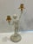 This pair of figural iron candelabra is painted ivory & gold Height 15.25 Width 8 Base diameter 5.5
