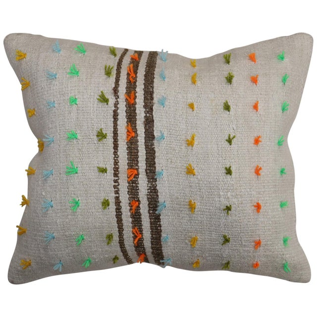 Pillow made from a vintage Turkish Kilim with colorful pops of wool stitched on giving it a bohemian vibe. Zipper closure...
