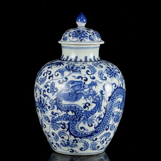This is an elegant vintage porcelain jar, crafted in the classic Chinese blue and white style. The jar features a classic...