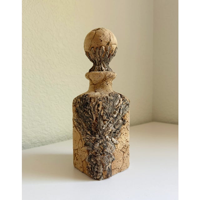 This vintage 1960s cork-wrapped glass decanter bottle adds a great texture to any space. Includes a round, cork-wrapped...