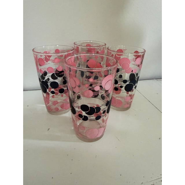 A fabulous set of four vintage Hazel-Atlas tallboy tumbler glasses from the 1950s, featuring the iconic “Atomic” motif...