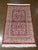 Machine-made Turkish wool rug featuring an all-over floral design set on a rich red field. The composition includes...