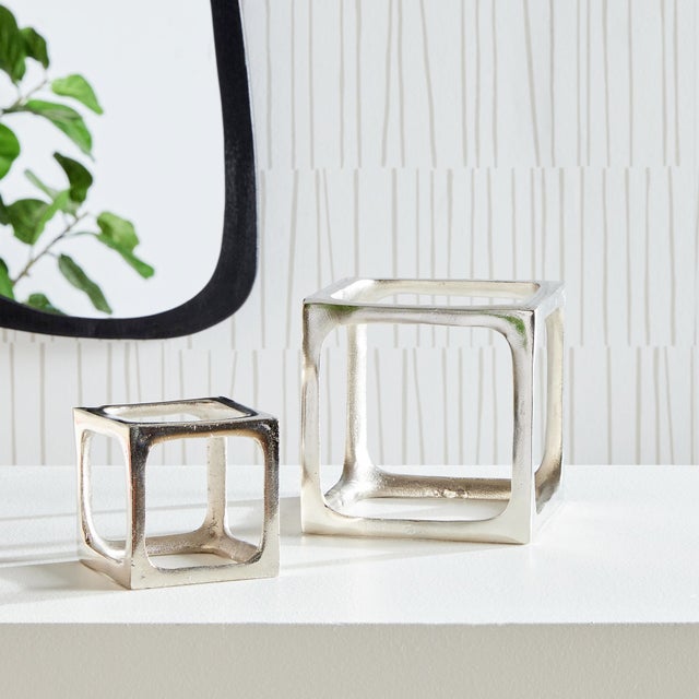 What is better than a simple three dimensional cast aluminum rendition of a square? A set of two. These cubist sculptures...